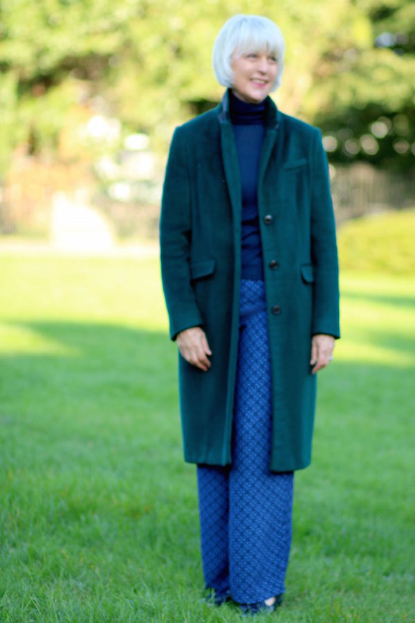 Green MandS coat with blue trousers