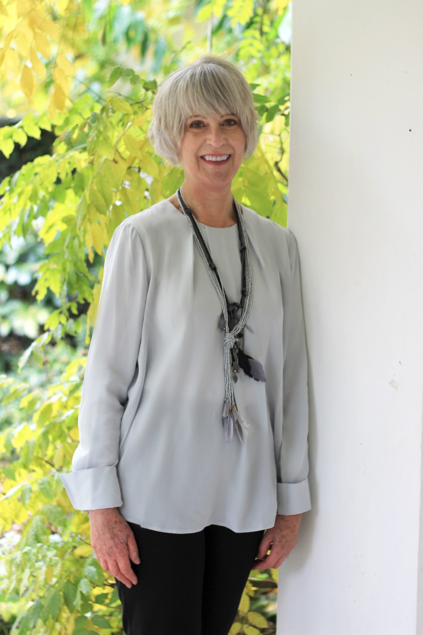 grey-silk-top-with-feather-necklaces