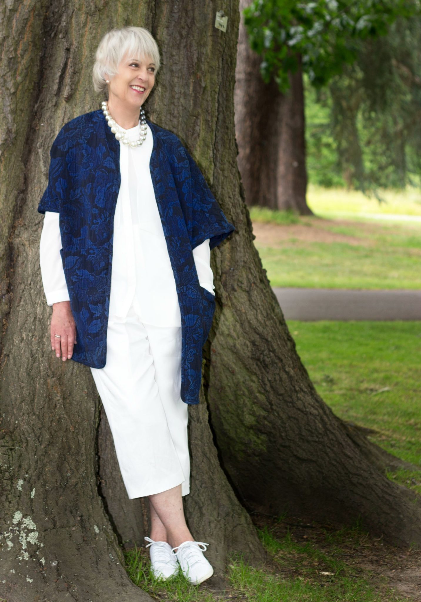 Navy statement coat, cream crop trousers cream top