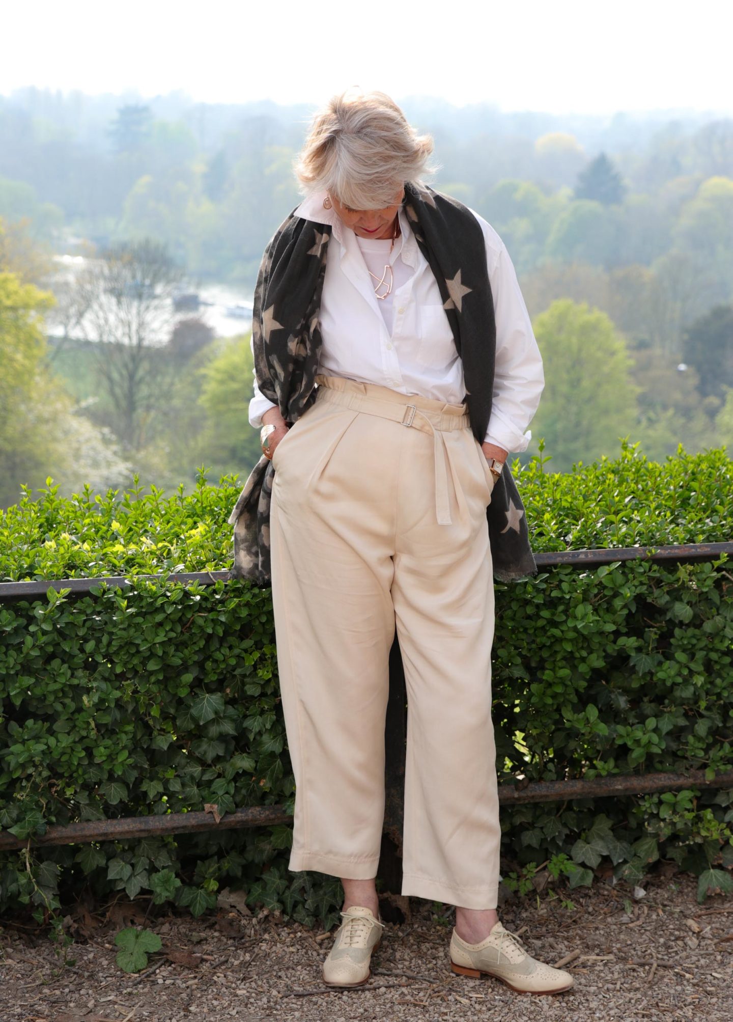 Beige trousers, white shirt star scarf