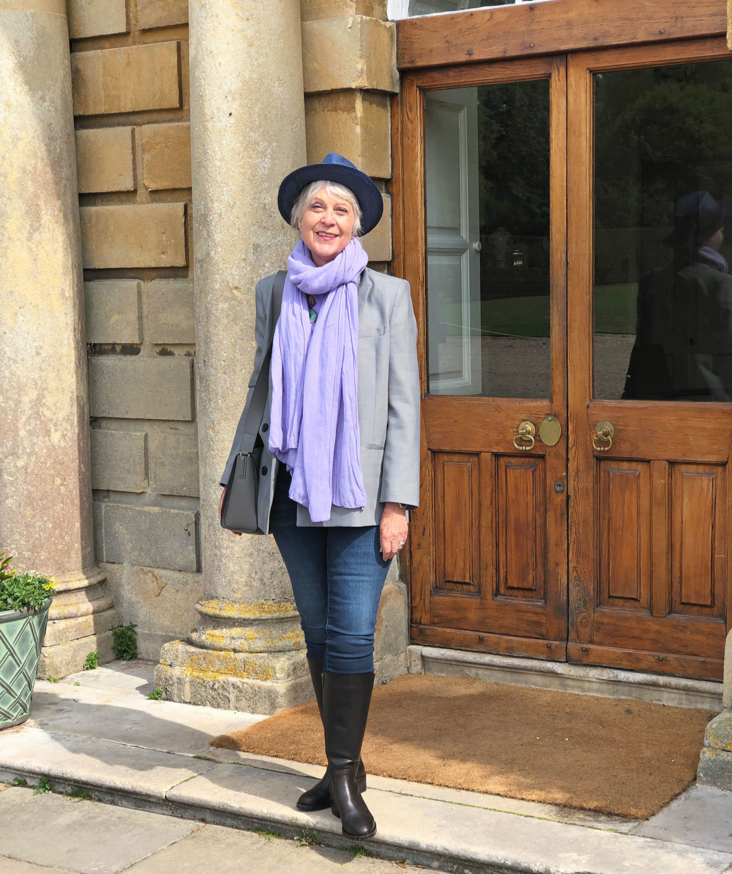 Lilac scarf, jeans, check jacket