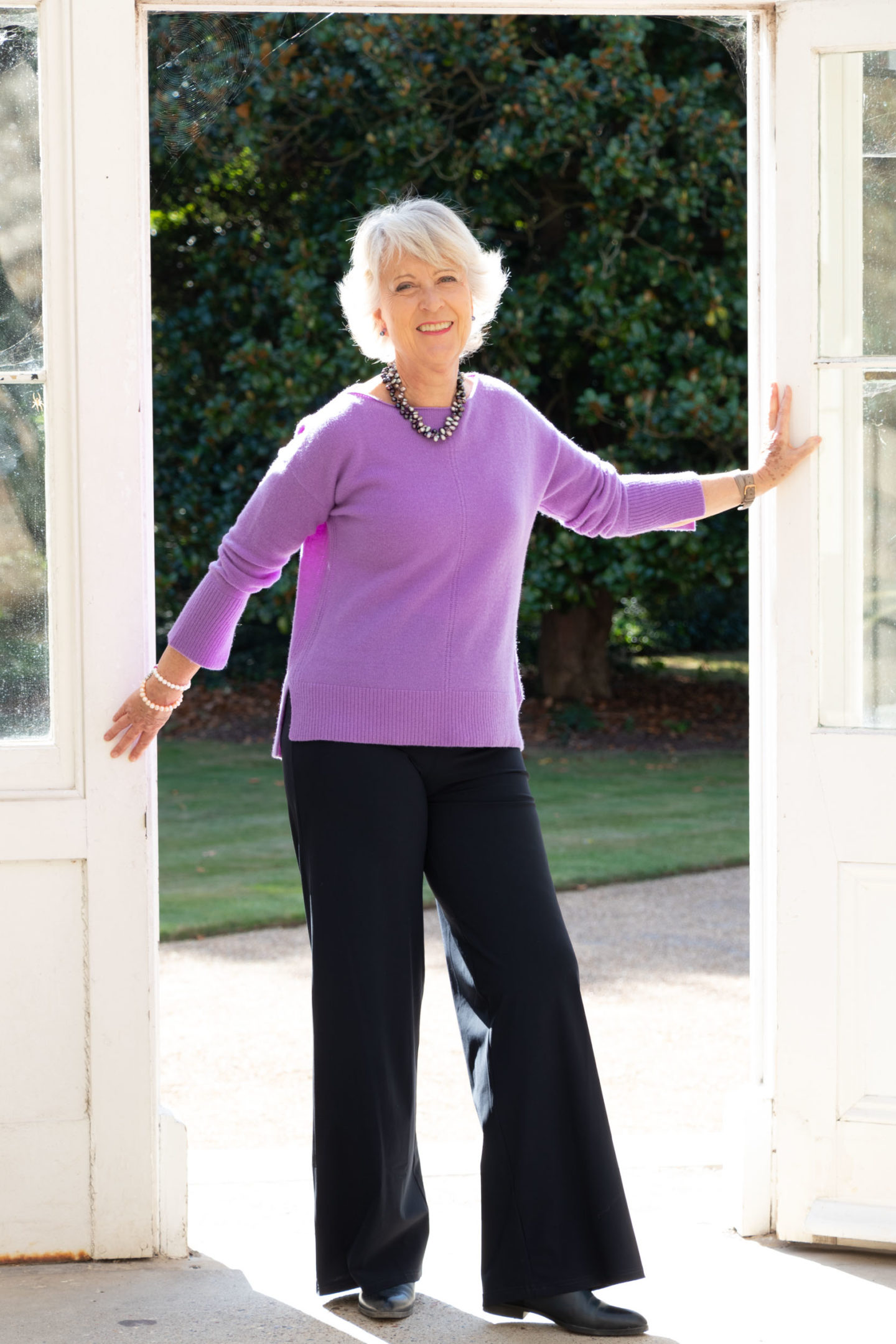 Purple sweater and navy trousers