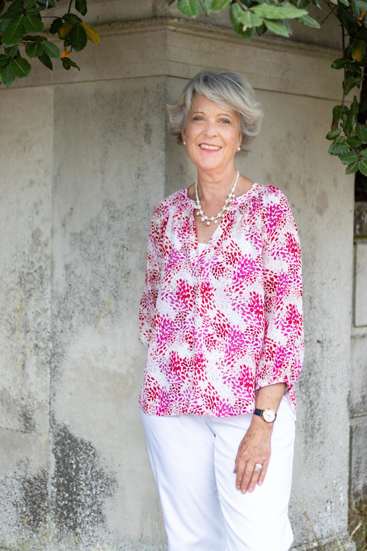 Pink print top and white trousers