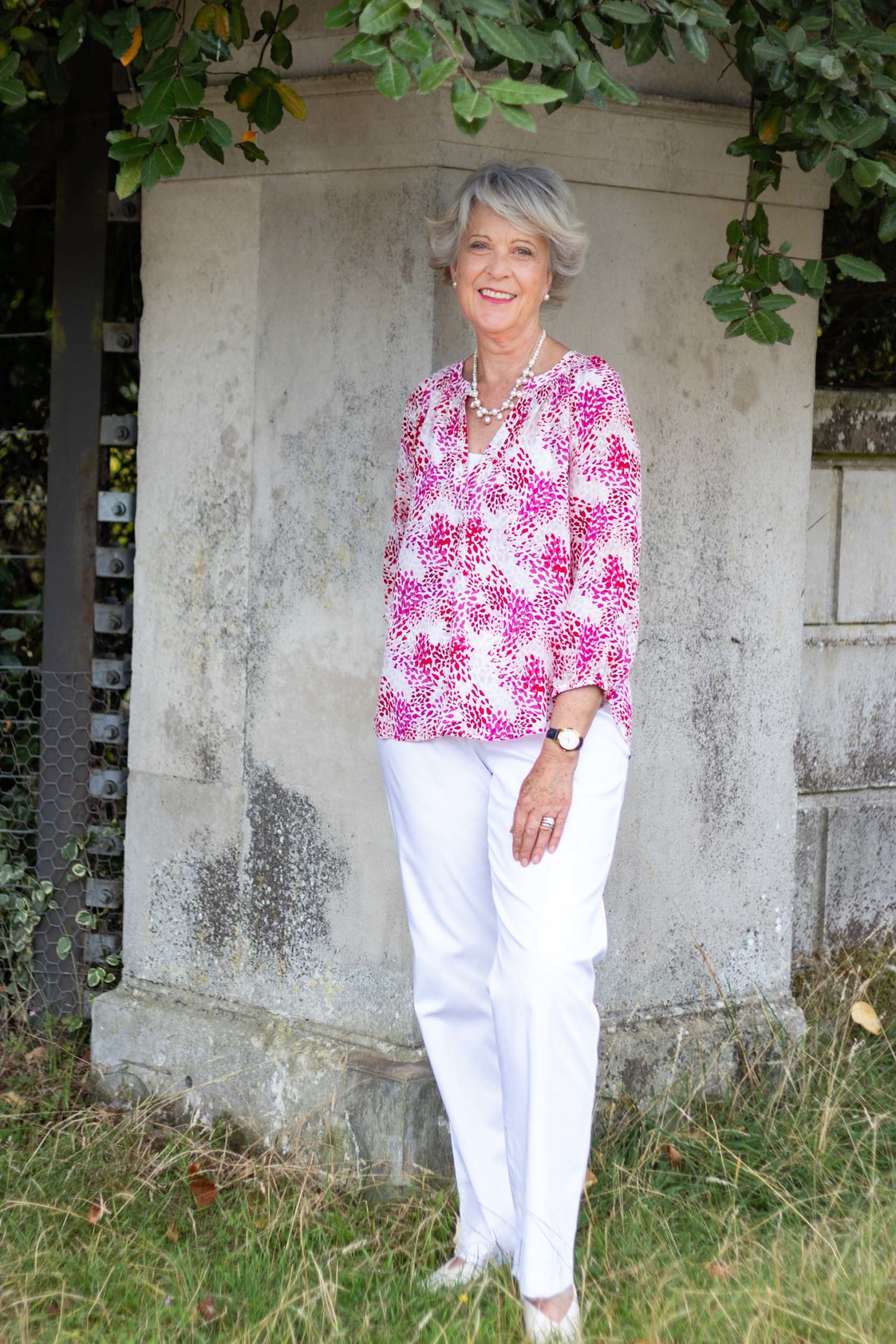 Pink print top and white trousers