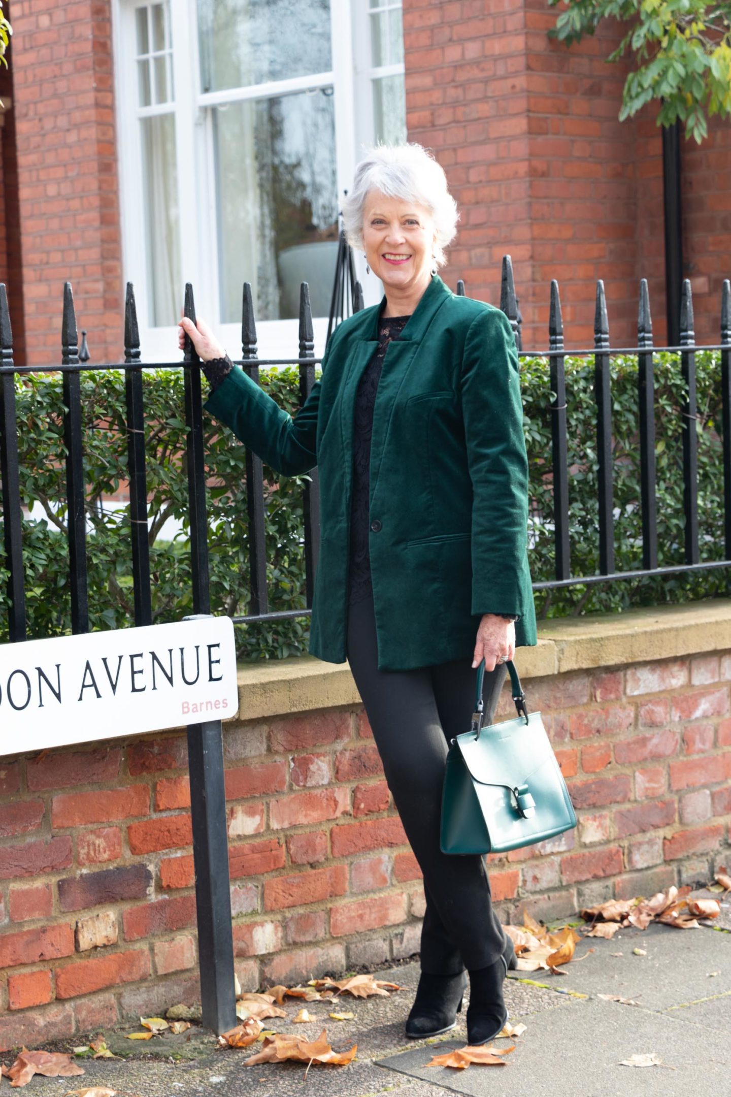 Green velvet jacket and black trousers