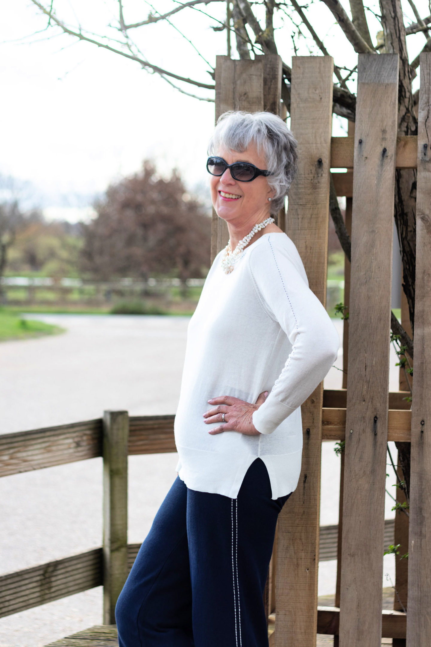 Cream cotton sweater and navy knit trousers