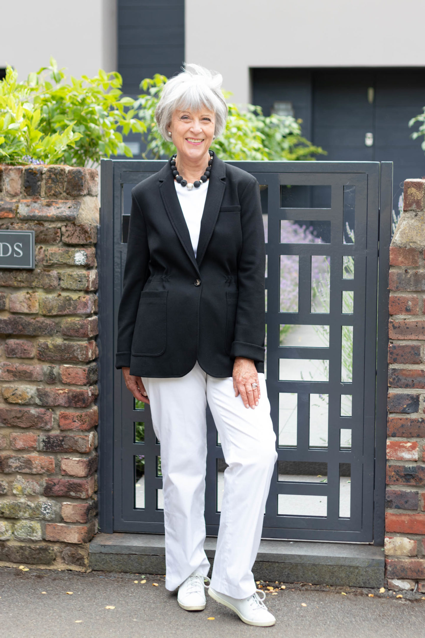 Black single breasted jacket and white trousers