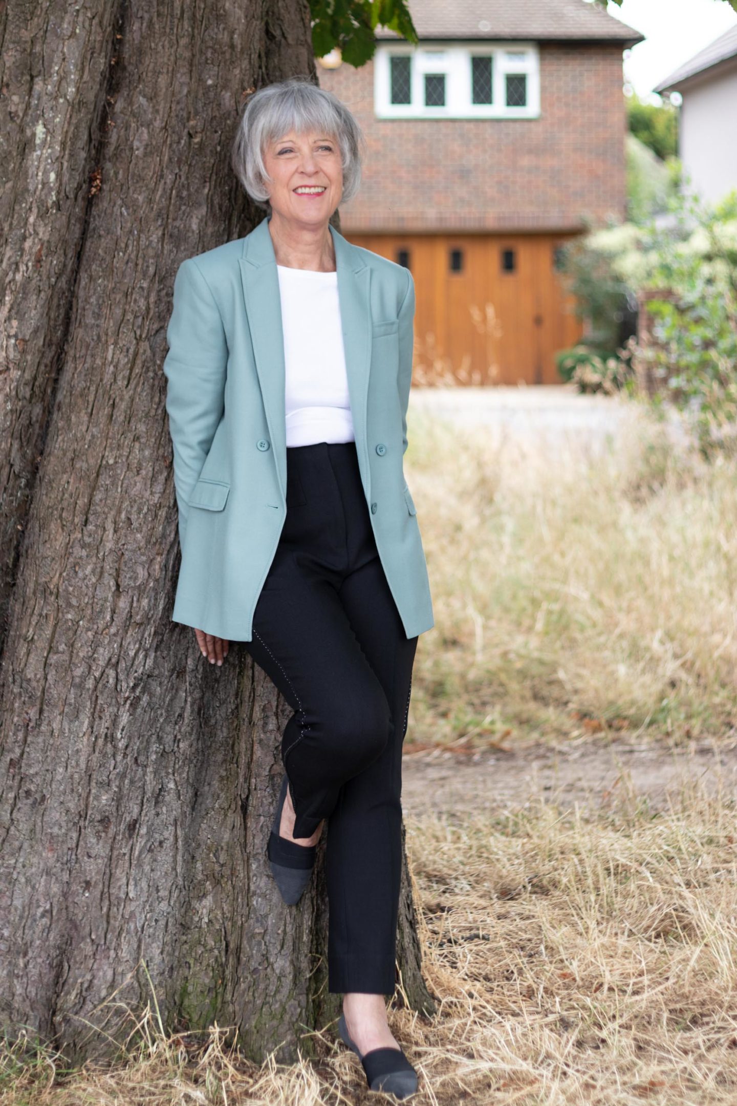 Green double breasted blazer, white tee and black trousers