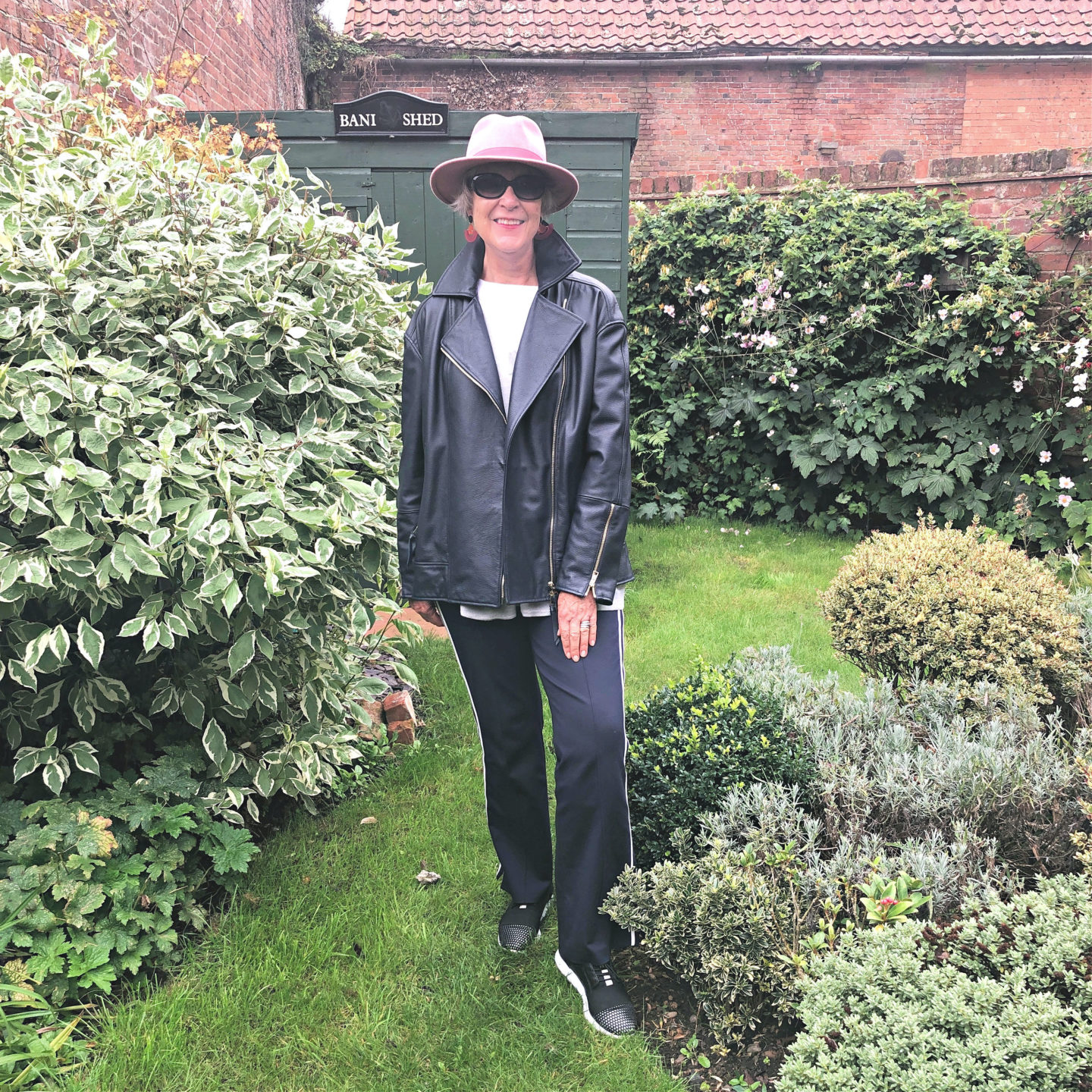 Navy leather jacket and casual trousers