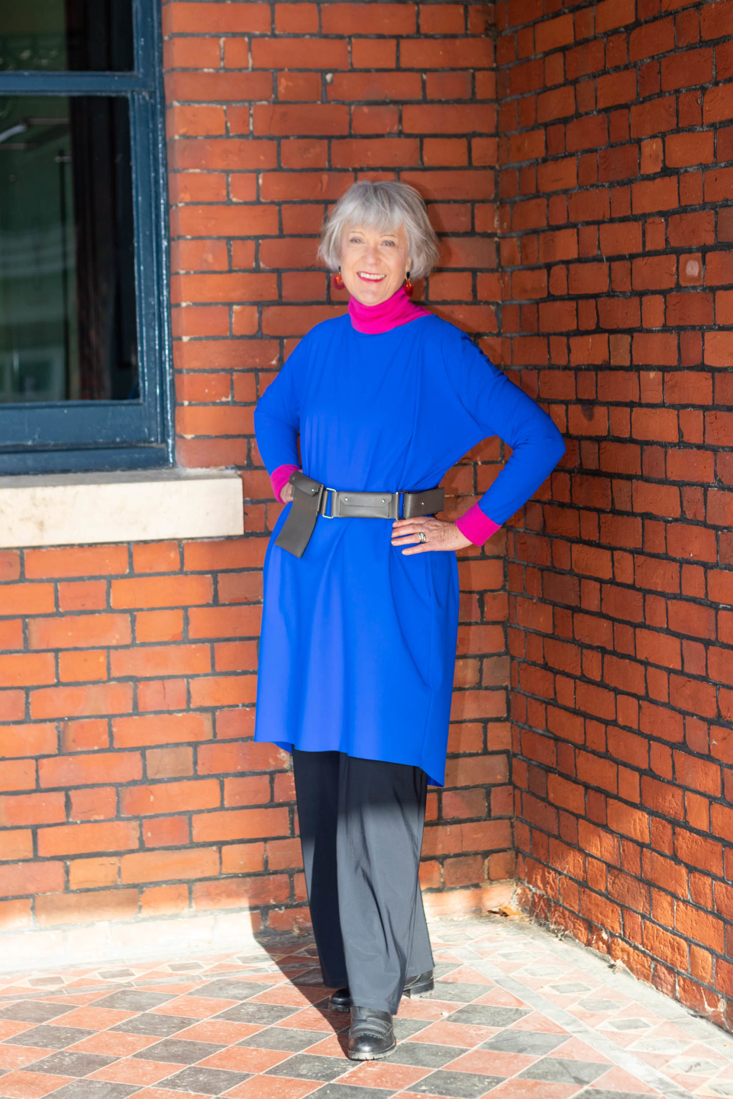 Bright blue dress, pink rollback and black trousers