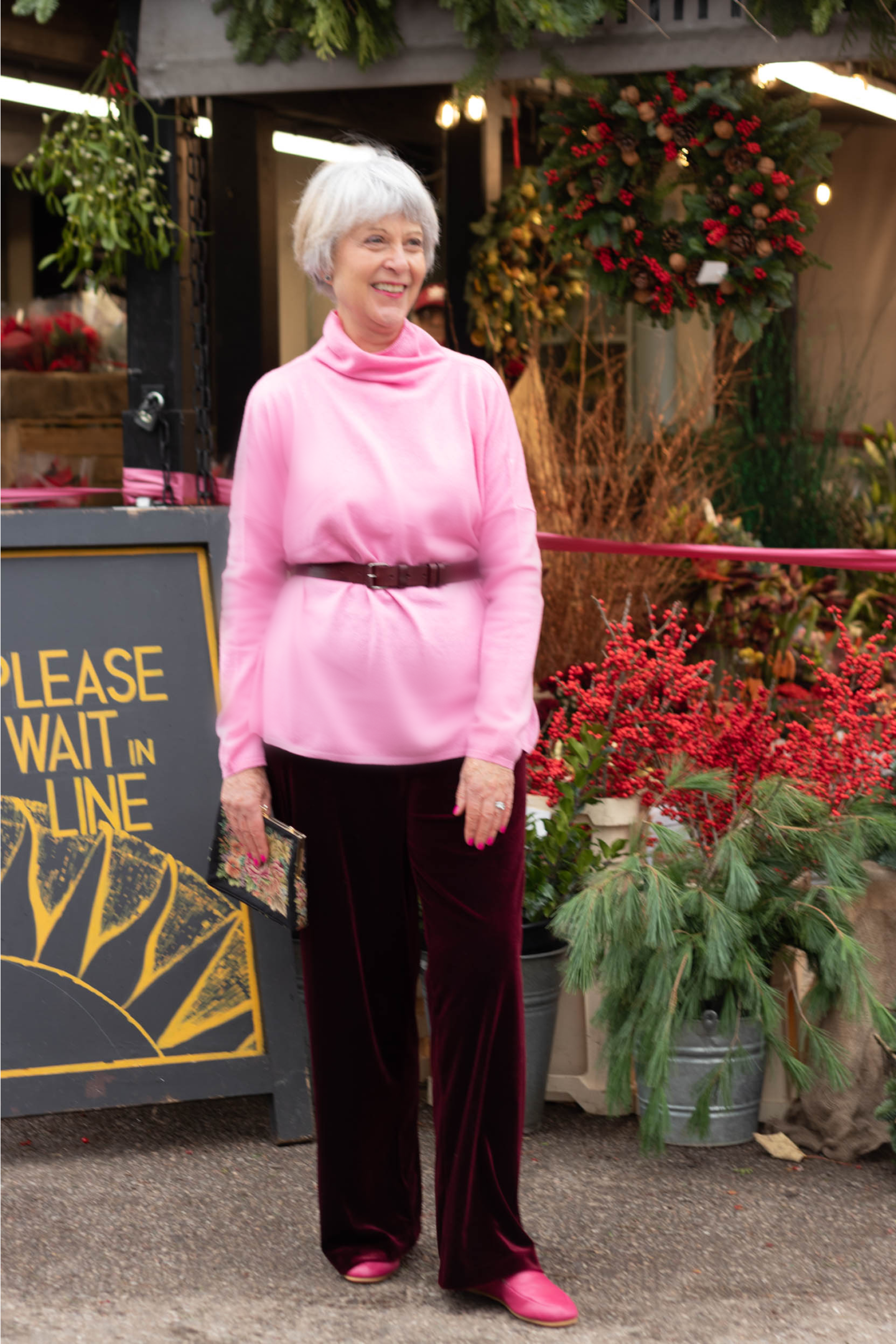 Pink roll neck sweater and black trousers 