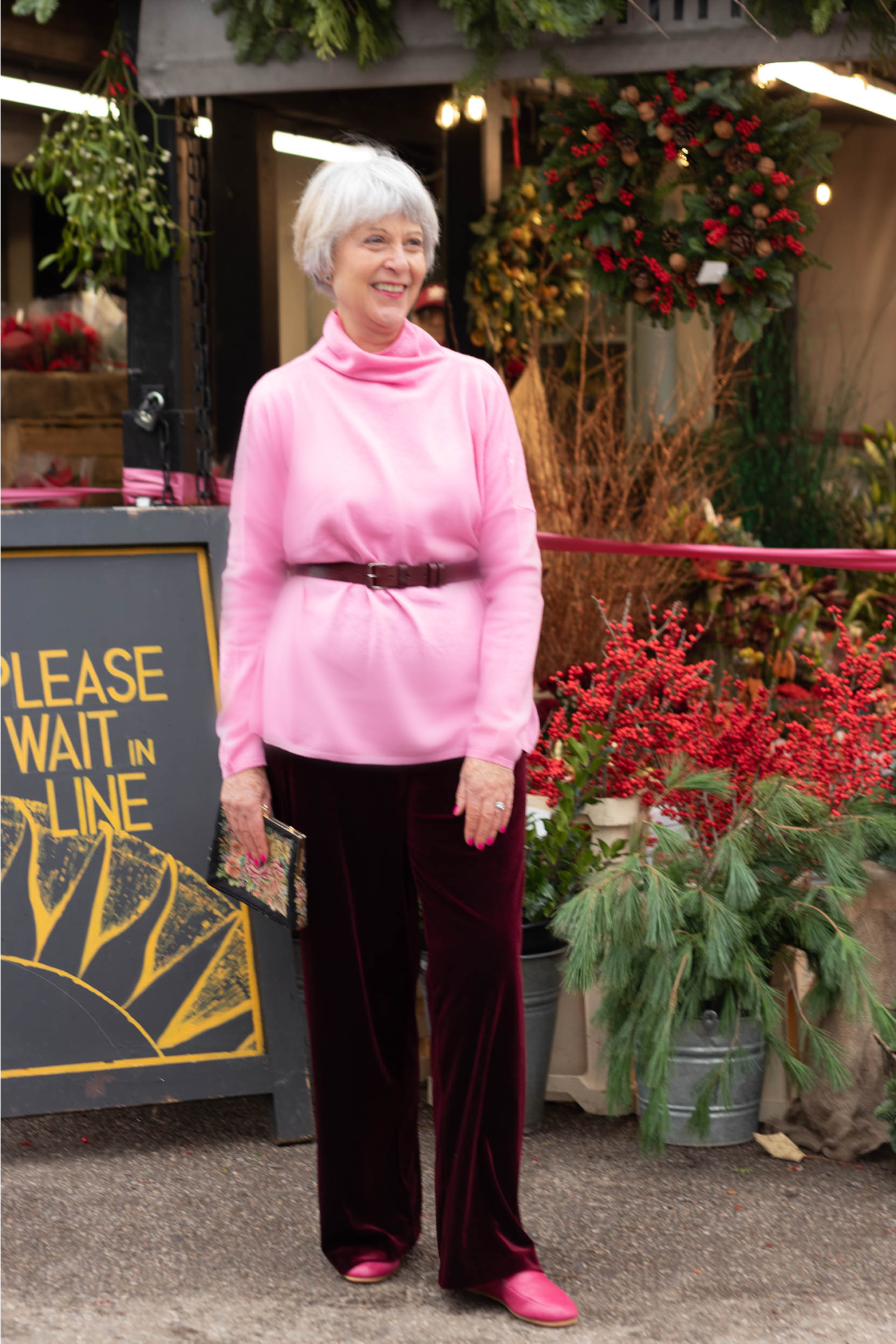 Pink roll neck sweater and black trousers