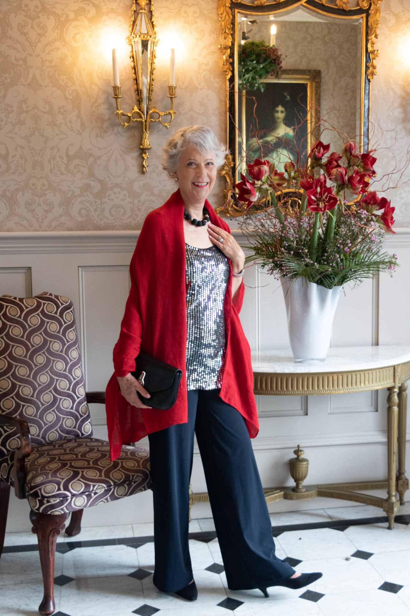 Sequin top, black trousers and red scarf