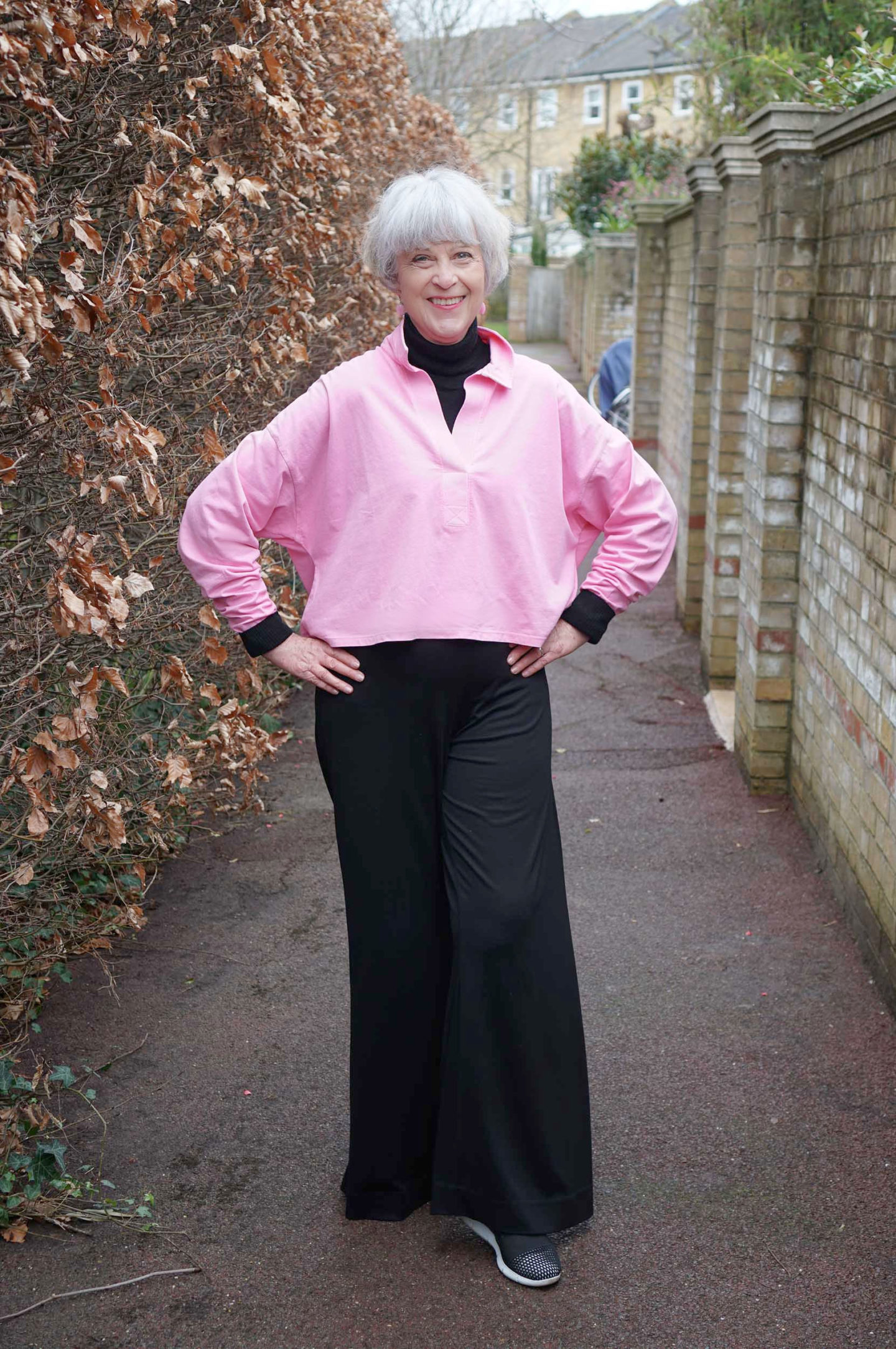 Pink cotton top and wide black trousers