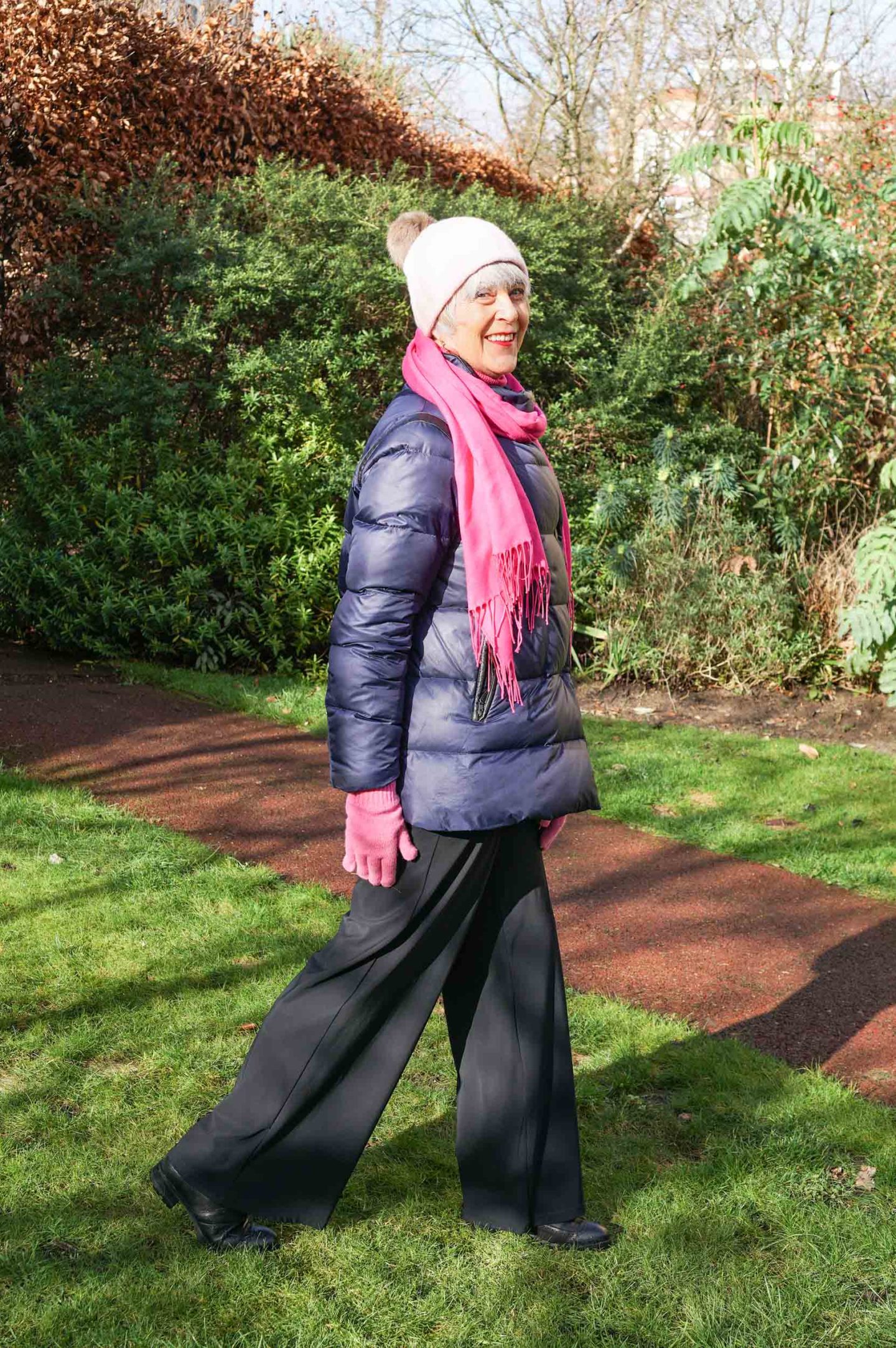 Navy puffer jacket and pink scarf