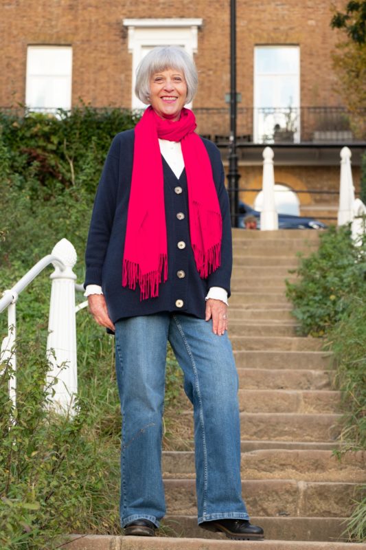 navy cashmere cardigan with bright red scarf.