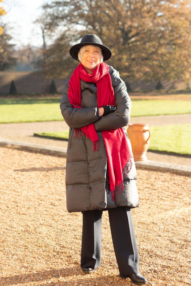 Black puffer jacket hat and red scarf