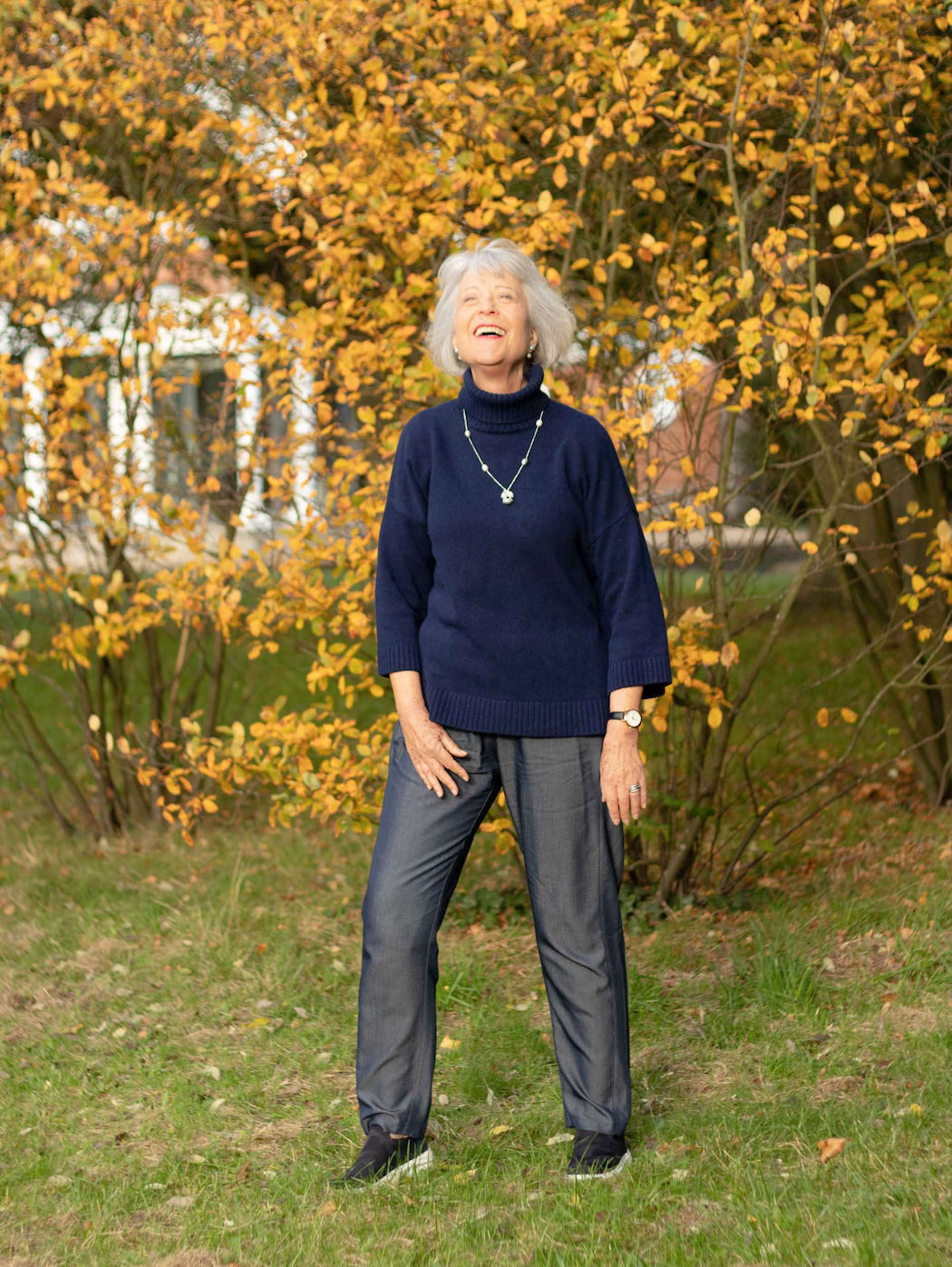 navy trousers and navy roll neck sweater