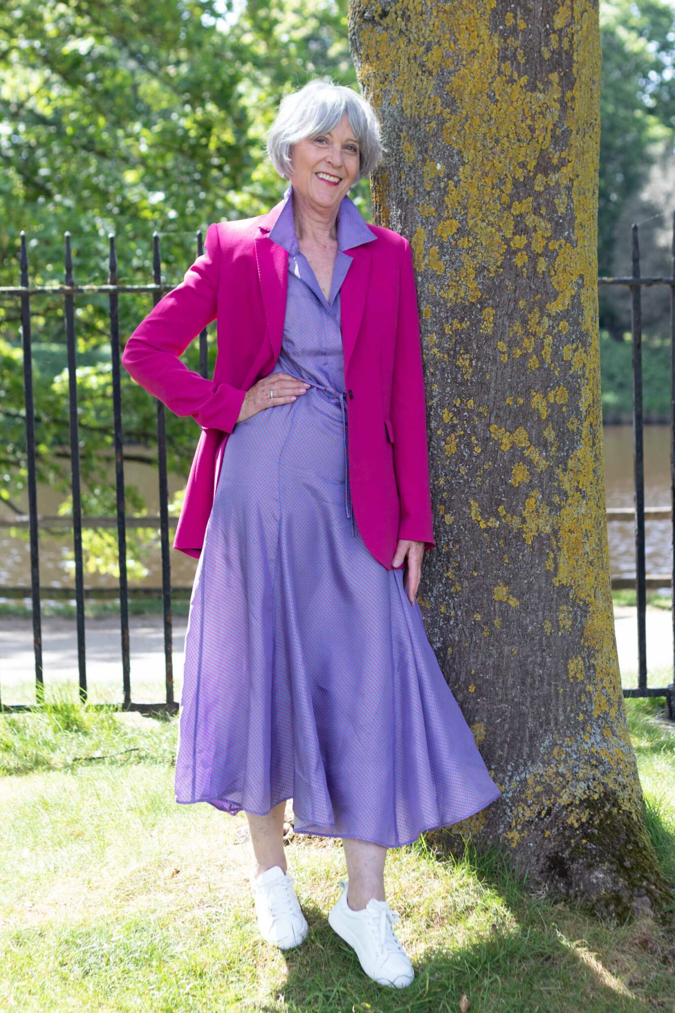 Purple maxi dress, pink jacket + white trainers
