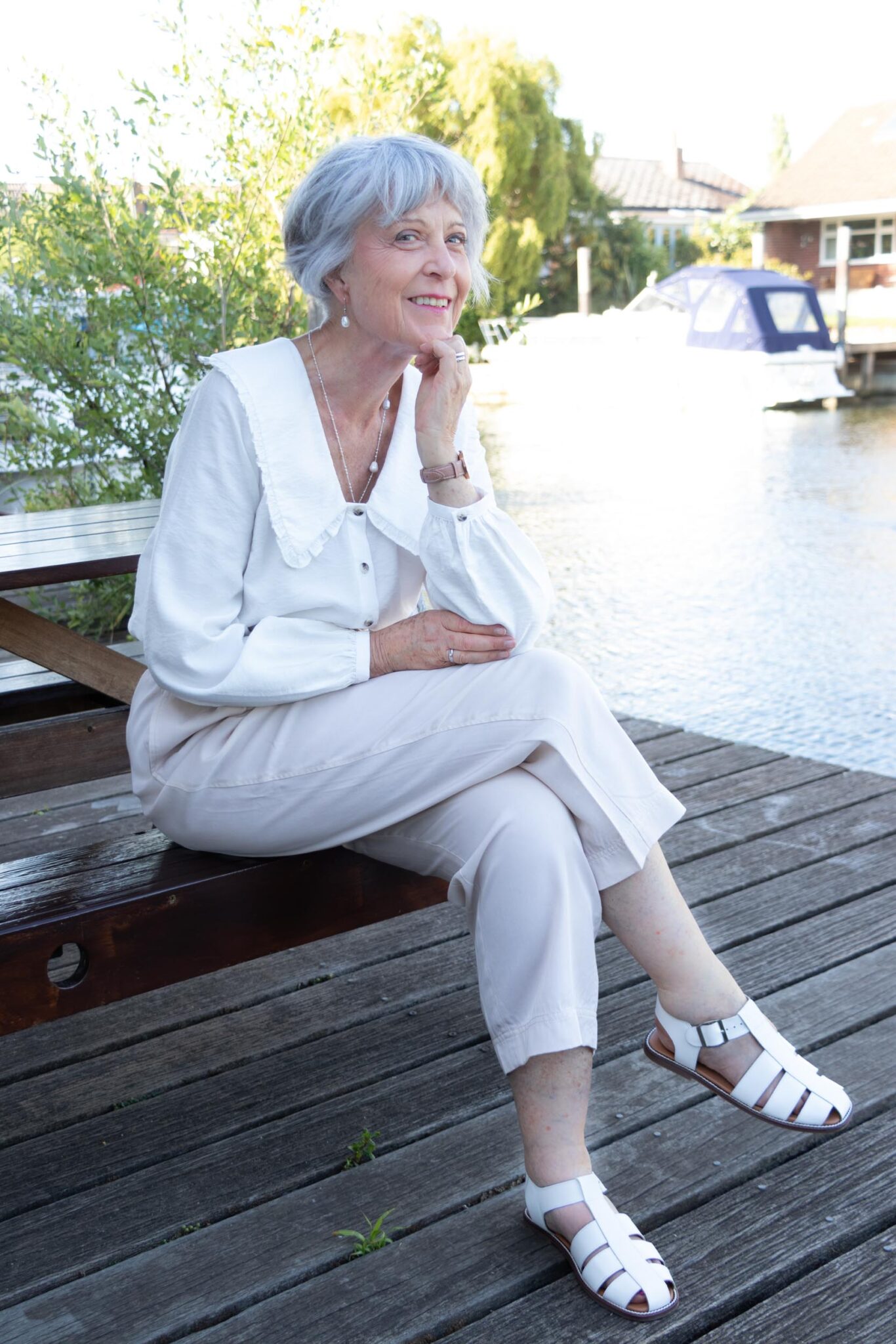 Feminine white blouse and beige trousers