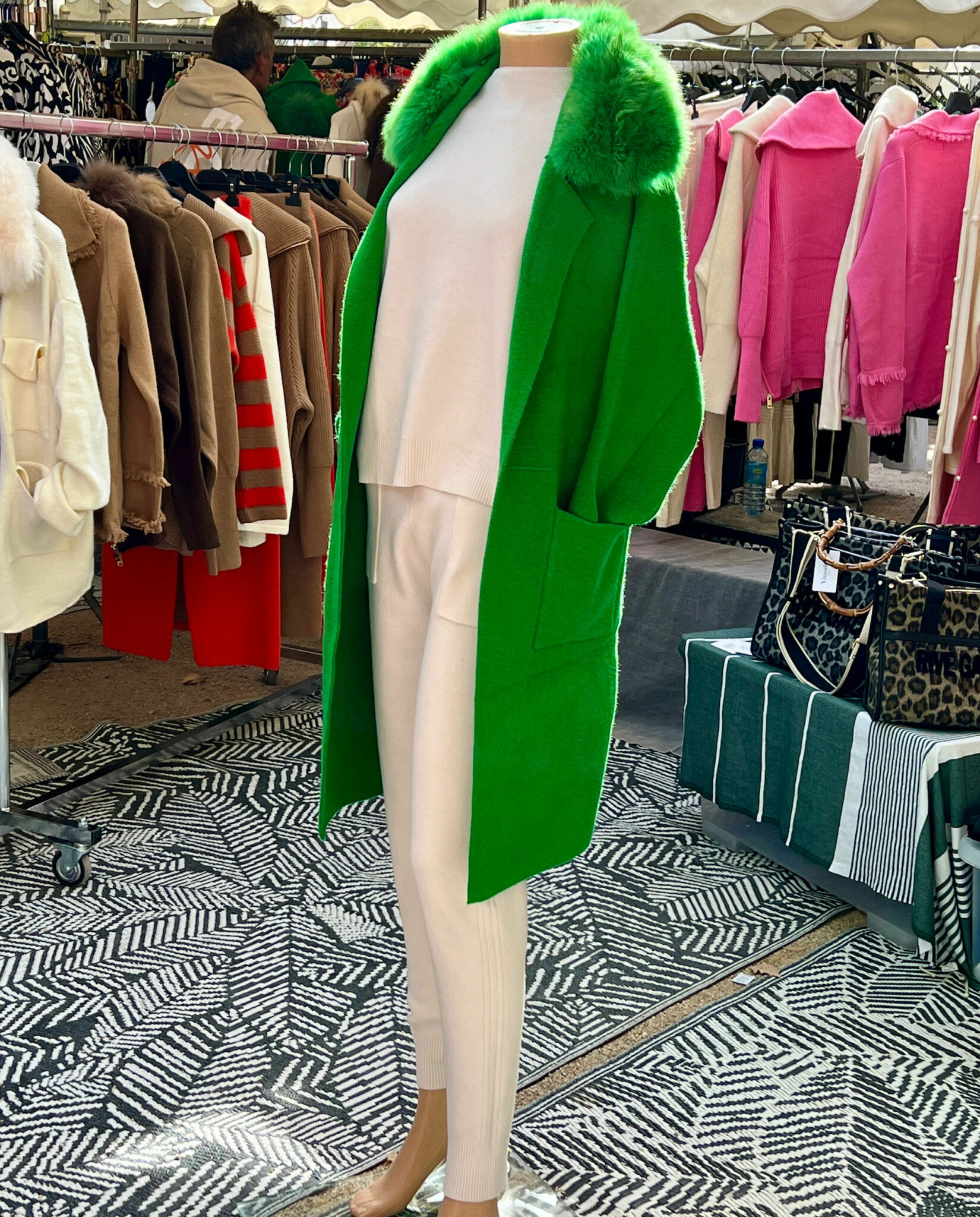 green cardigan coat over cream trousers and top