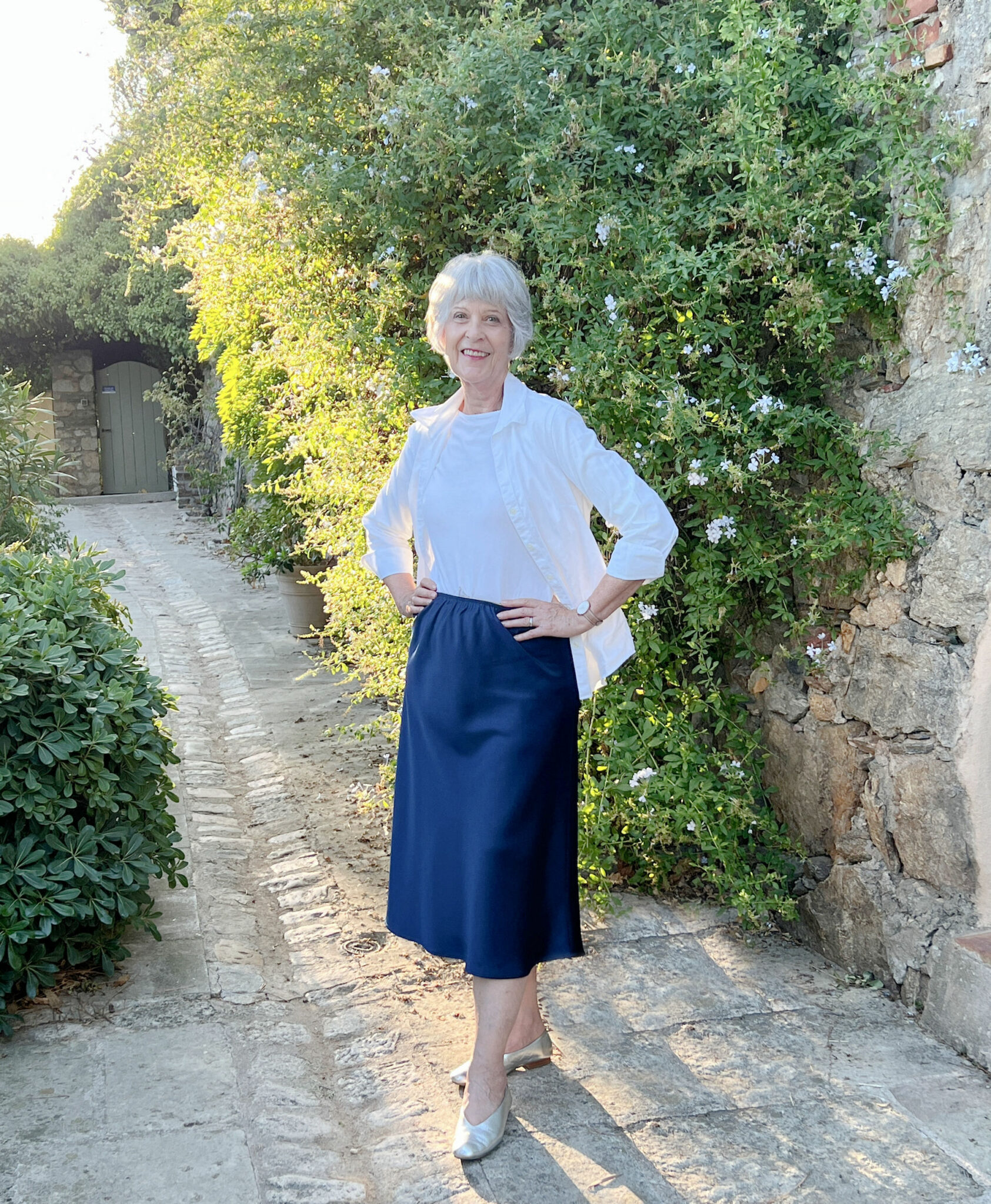 Navy bias cut skirt worn casually with white shirt