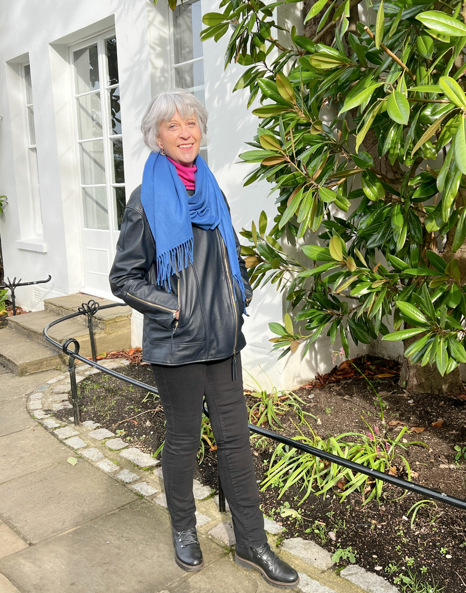 Black leather jacket and blue cashmere scarf..