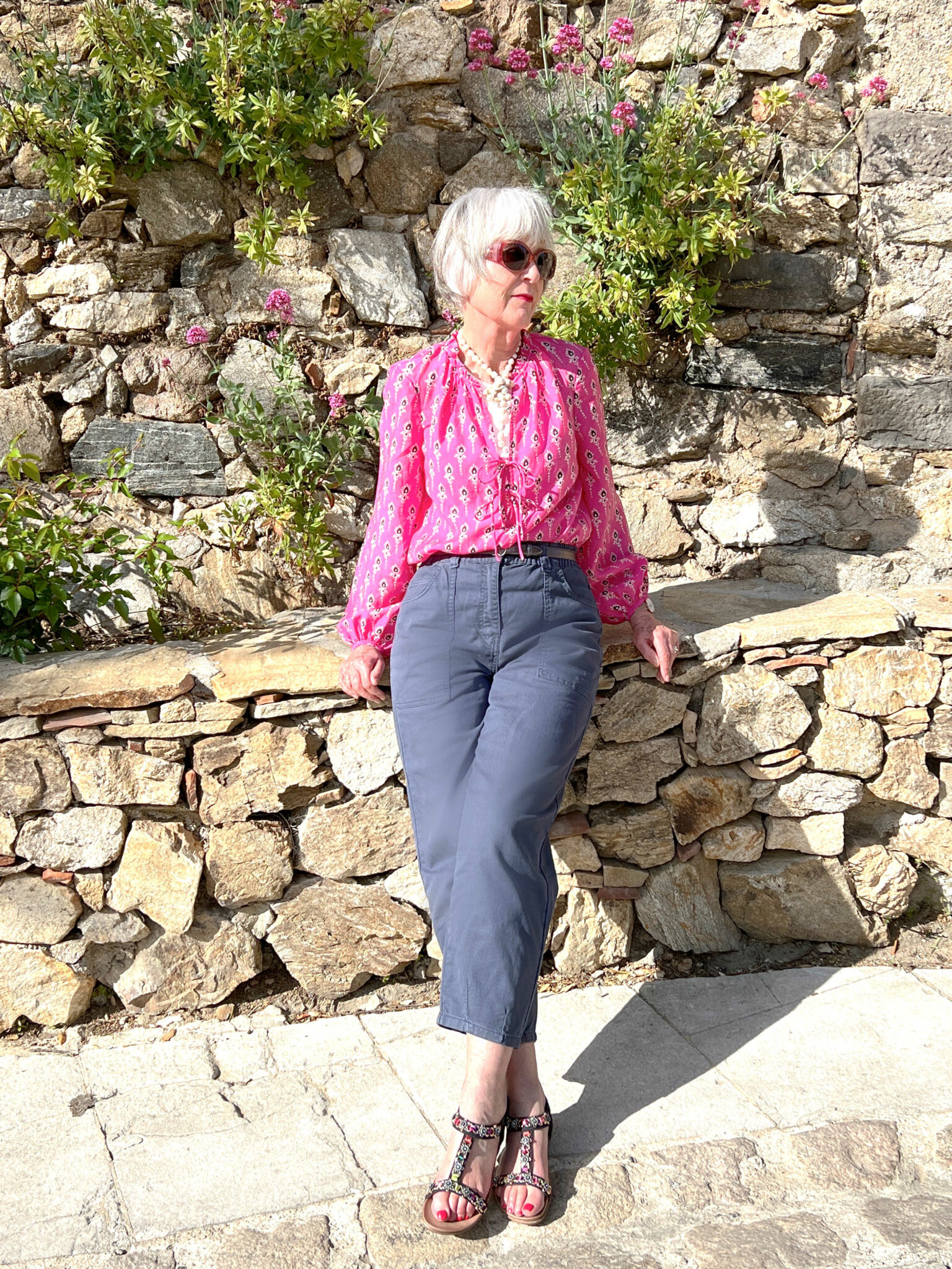 Pink print blouse and grey jeans