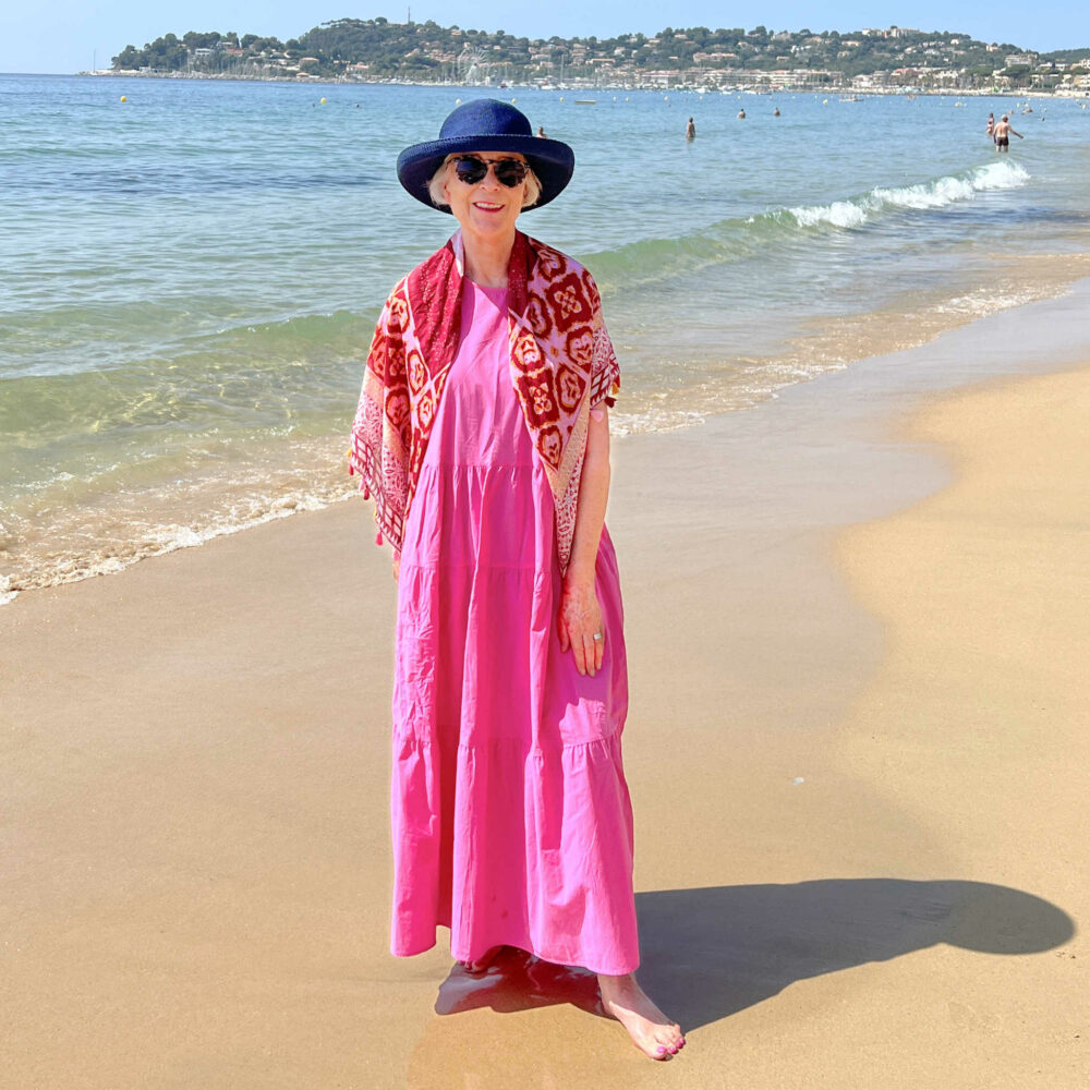 Pink sundress and scarf on beach