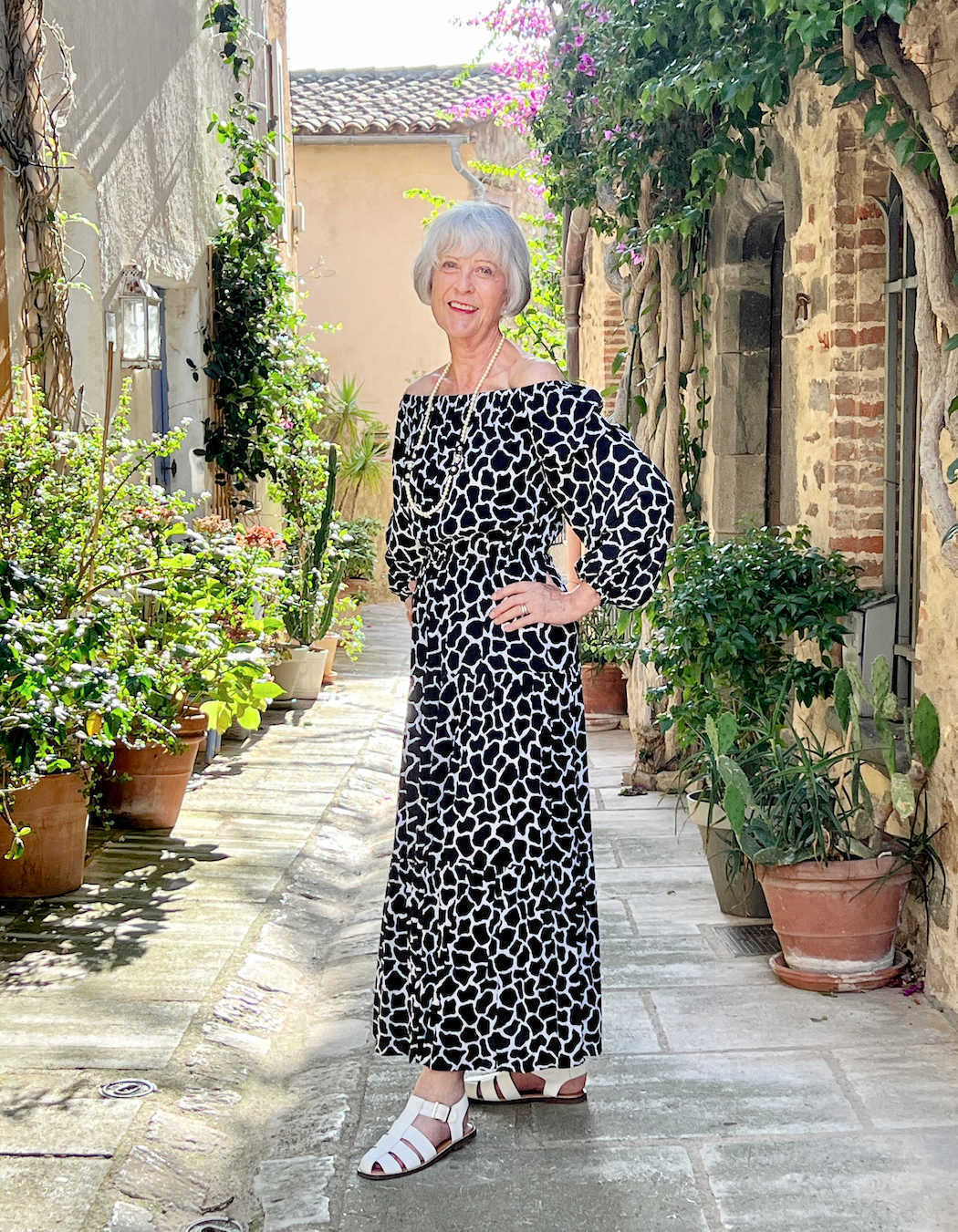 Black print dress worn off the shoulder